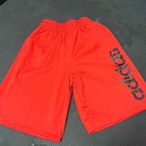 Red Adidas shorts.